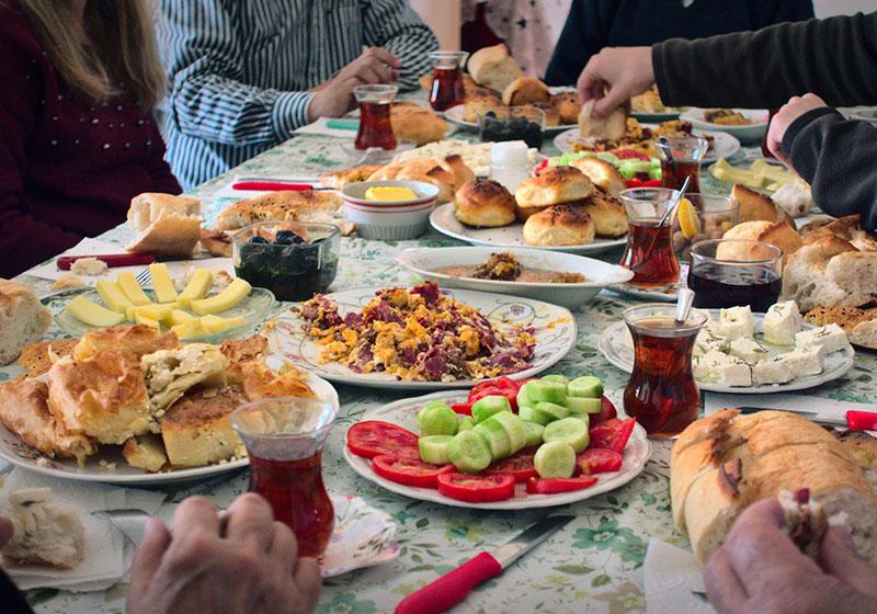 Buffet of variety food dishes shared on a large table