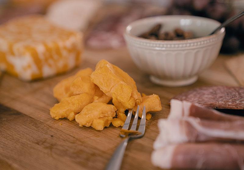 Featured cheddar cheese on cutting board