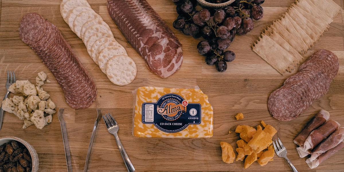 Assorted meats and cheeses on a cutting board